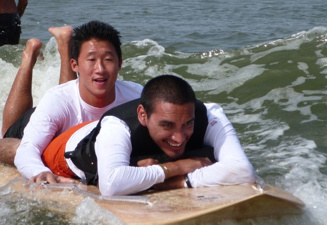 KORE volunteer helps a disabled young man enjoy the surf. Photo by Pamela Varma Brown
